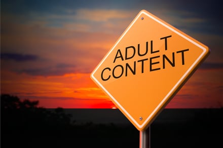 Adult Content on Warning Road Sign on Sunset Sky Background.