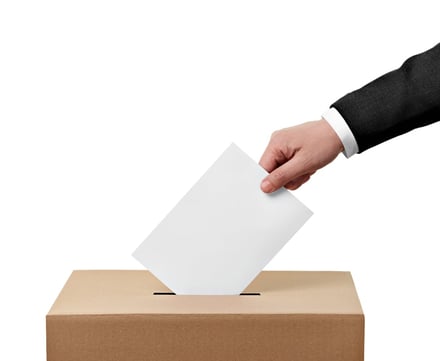 close up of a ballot box and casting vote on white background