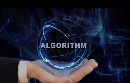 Hand holding Algorithm orb against a dark background